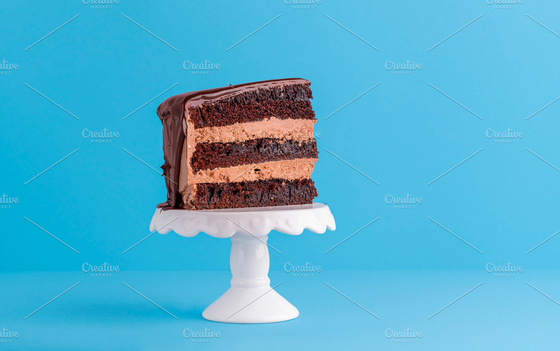 Slice of chocolate layered cake on w, a Food & Drink Photo by YesPhotographers