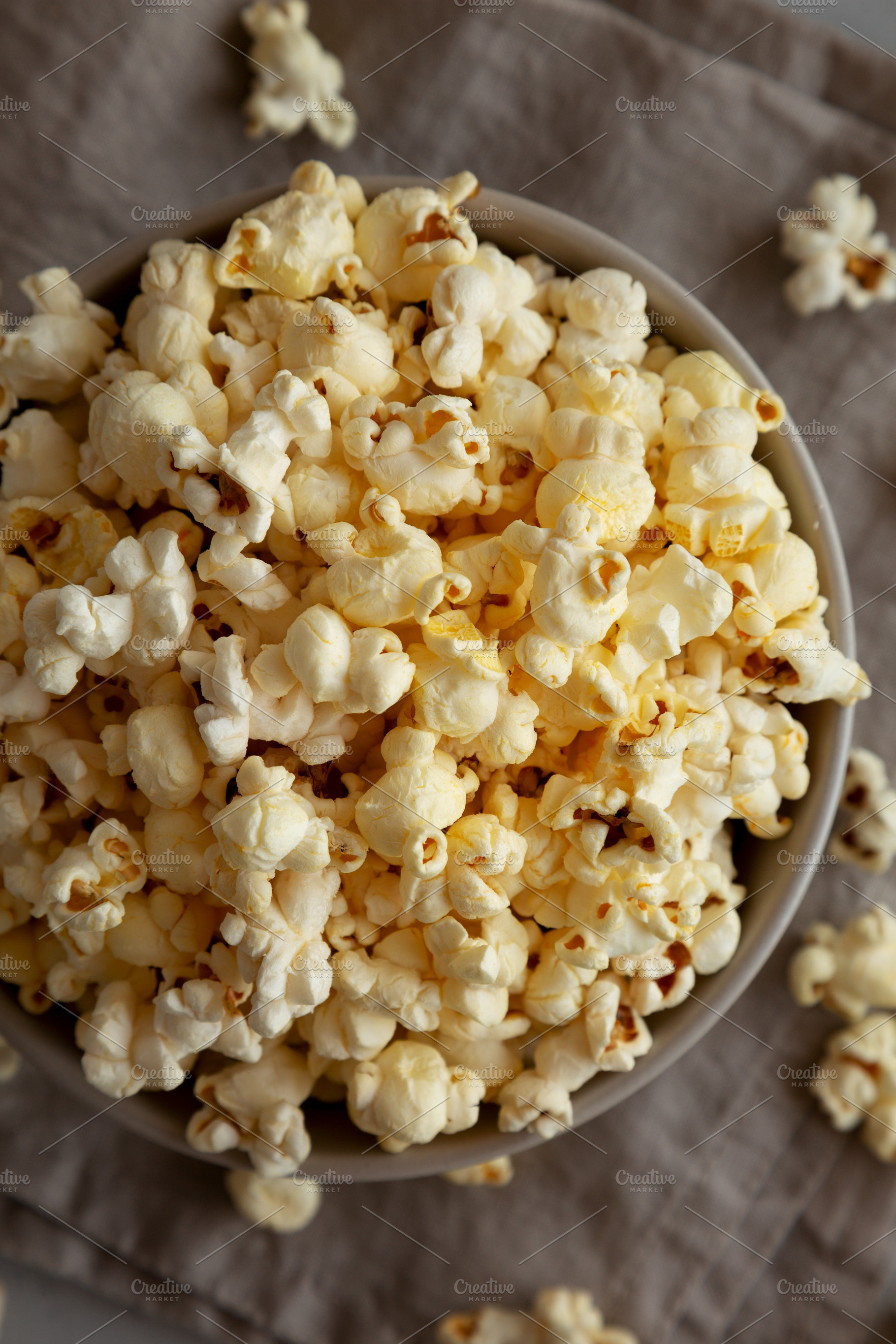 Homemade Salty Popcorn in a Bowl, top view., a Food & Drink Photo by LiudmylaChuhunova