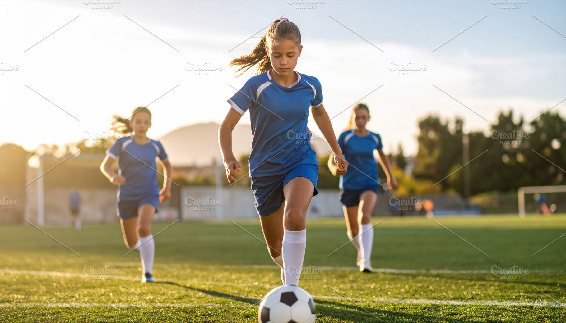 Young girl soccer player dribbling on field, a Sports & Recreation Photo by Davizro's Market