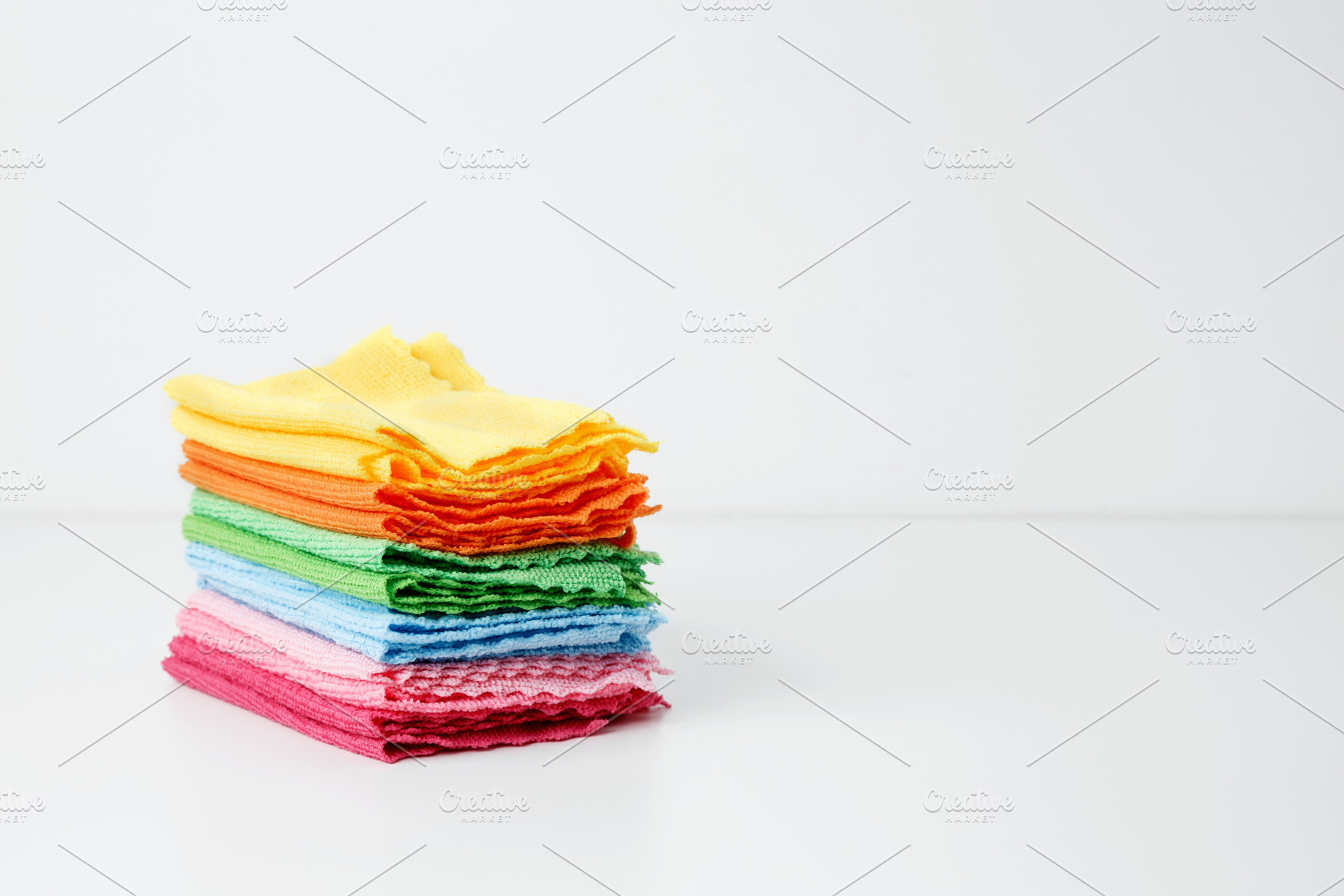 Colorful cleaning cloths neatly arranged, bringing brightness and energy to spr, a Photo by matucha