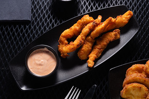 Chicken Nuggets with Garlic Sauce in Black Plate on Dark Table,, a Photo by MDBildes