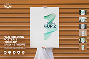 Man Holding Poster 2 Mock-up, a Print Template by Branda Keeps (Thumbnail 1 of 16)