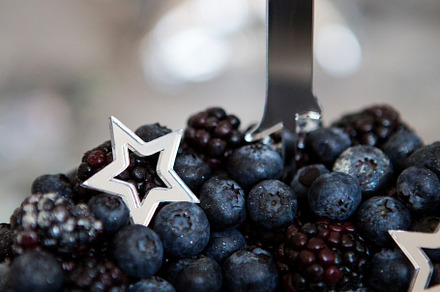 Black cake with stars and berries containing black, cake, and berry, a Food & Drink Photo by SaulichPhoto