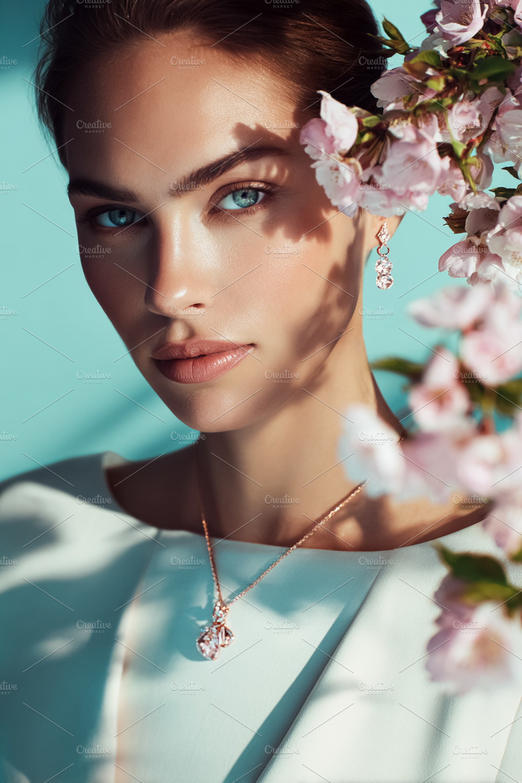 Woman's portrait with cherry blossoms and rose gold jewelry, exp, a Photo by Studio ANNA