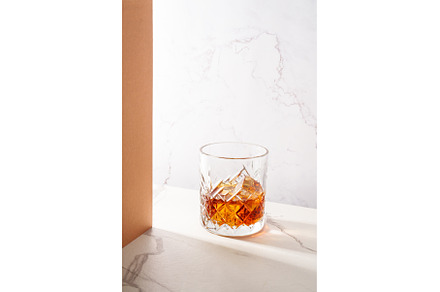 Whiskey with ice cube in the glass