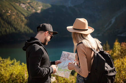 Young tourist couple, man and woman, on hiking path in mountains, a Person Photo by Olena Rudo