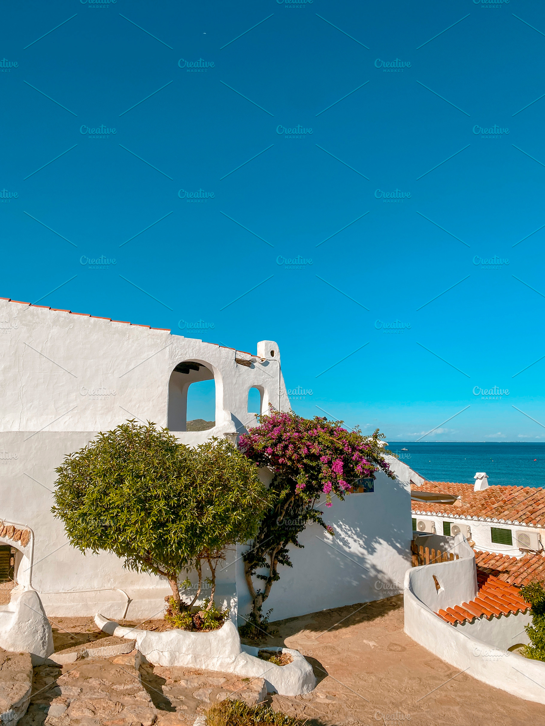 white houses by the sea in La Almadrava, Spain, a Photo by Nito