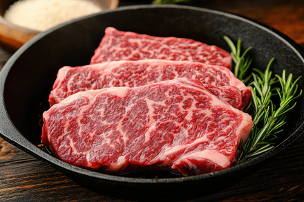 Juicy marbled steak cuts resting in, a Photo by Tanuart