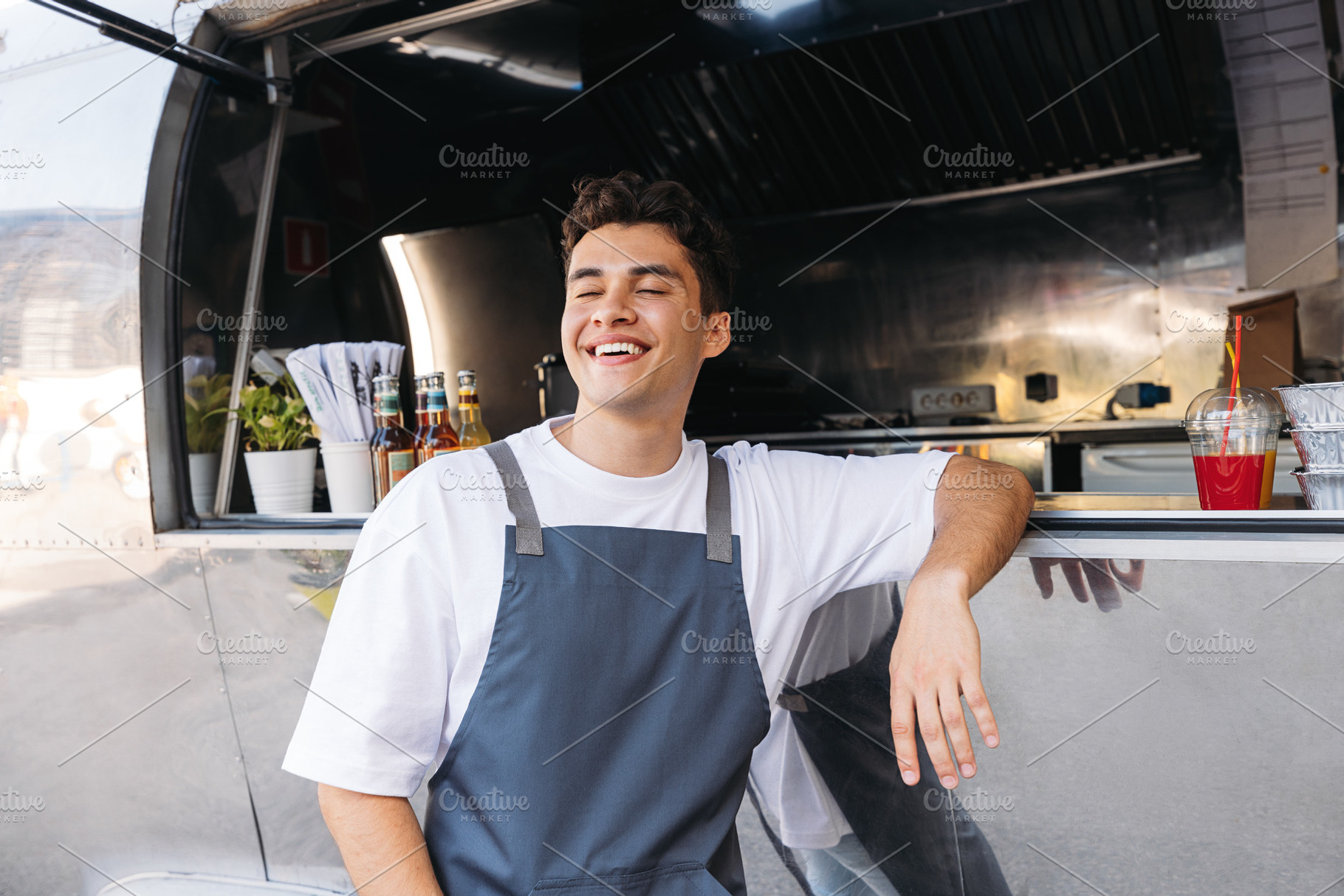 Cheerful food truck owner, a Person Photo by Artem Varnitsin