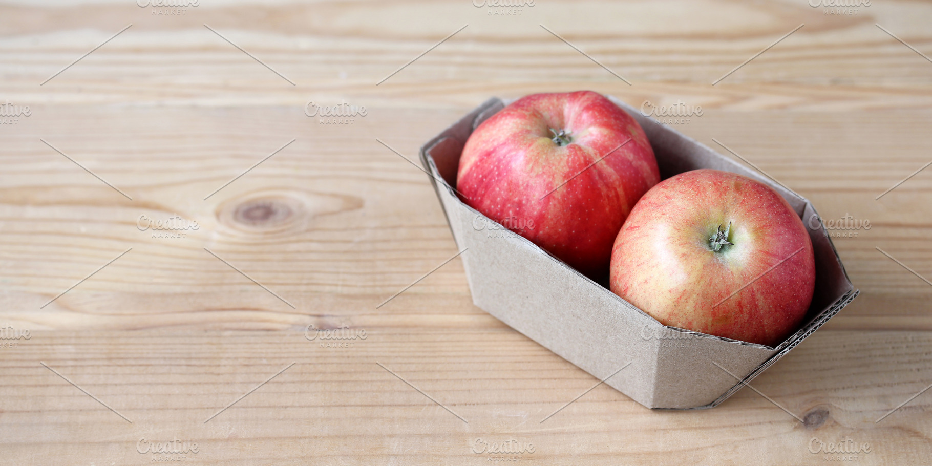 Red apples in cardboard packaging, a Food & Drink Photo by BalaguR