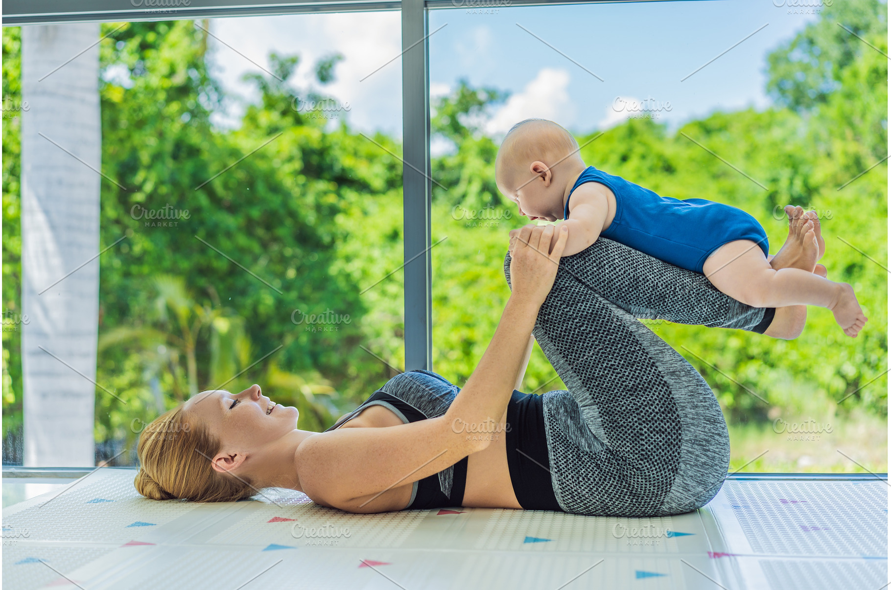 Mother doing fitness exercises while, a Person Photo by Elizaveta Galitskaya
