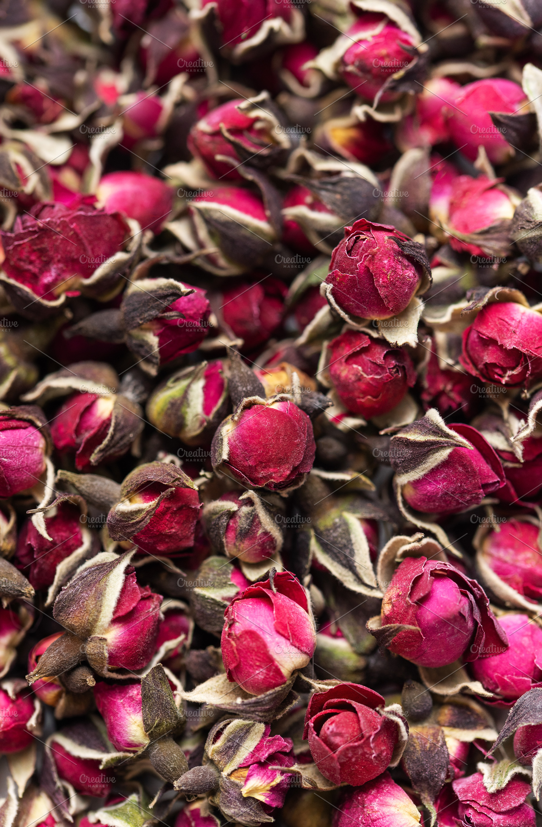 Dried rose buds creating fragrant herbal tea concept, a Food & Drink Photo by Olena Rudo