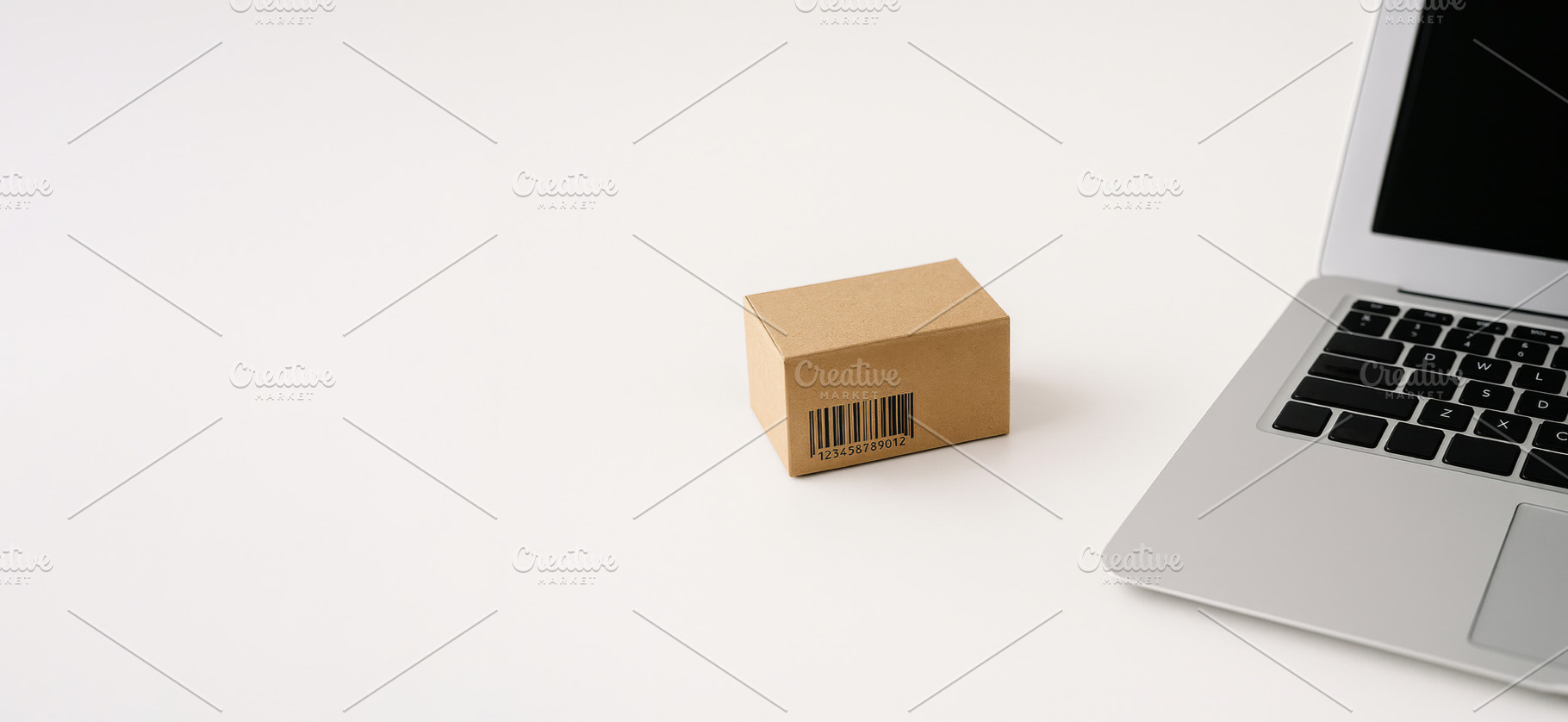 Cardboard box and laptop on white ba, a Photo by Dvoevnore photos