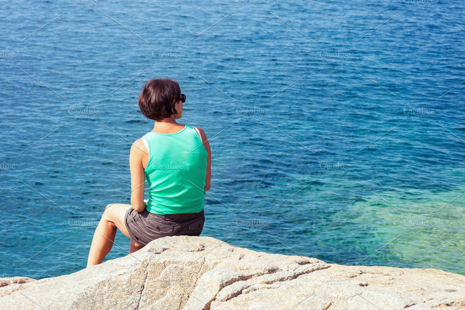 Young woman looking at sea, a Person Photo by BOOCYS
