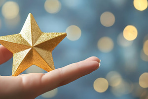 Hand holding a glittering golden star against blurred lights, an Abstract Photo by Natalia Klenova's Shop