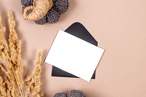 Black envelope with empty white card for text on beige backgroun, a Holiday Photo by vimart