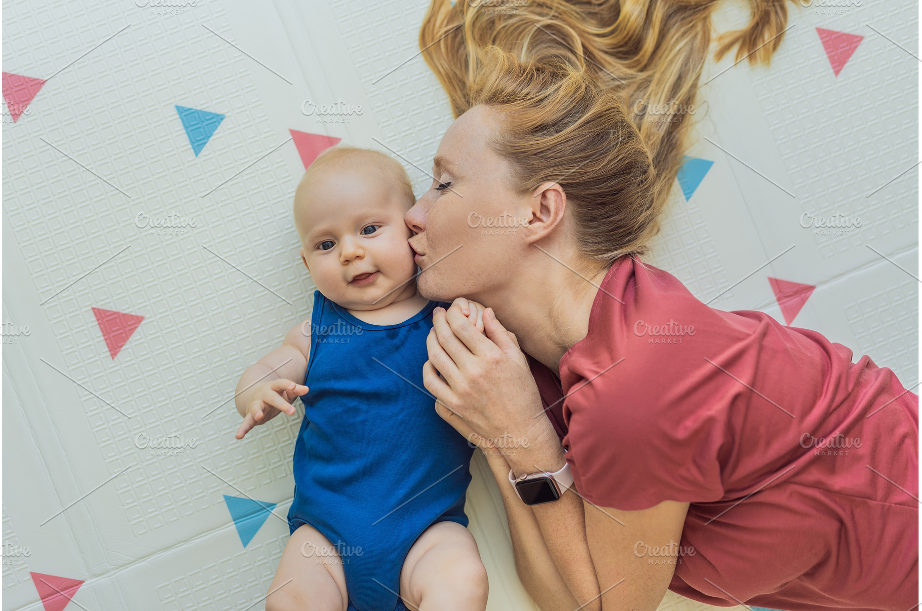 Mother and baby lying on a soft play, an Architecture Photo by Elizaveta Galitskaya