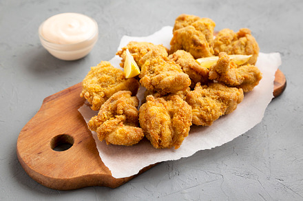 Homemade traditional japanese fried chicken Karaage on a rustic, a Food & Drink Photo by LiudmylaChuhunova