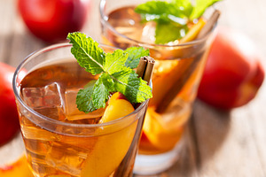 Refreshing peach iced tea in glass with ice cubes and cinnamon, a Food & Drink Photo by etorres69