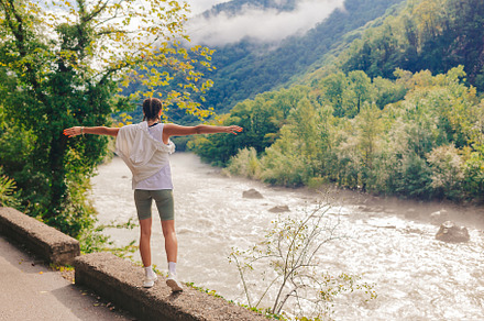 Happy romantic woman look at the river in mountain in Abkhazia, a Person Photo by travnikovstudio