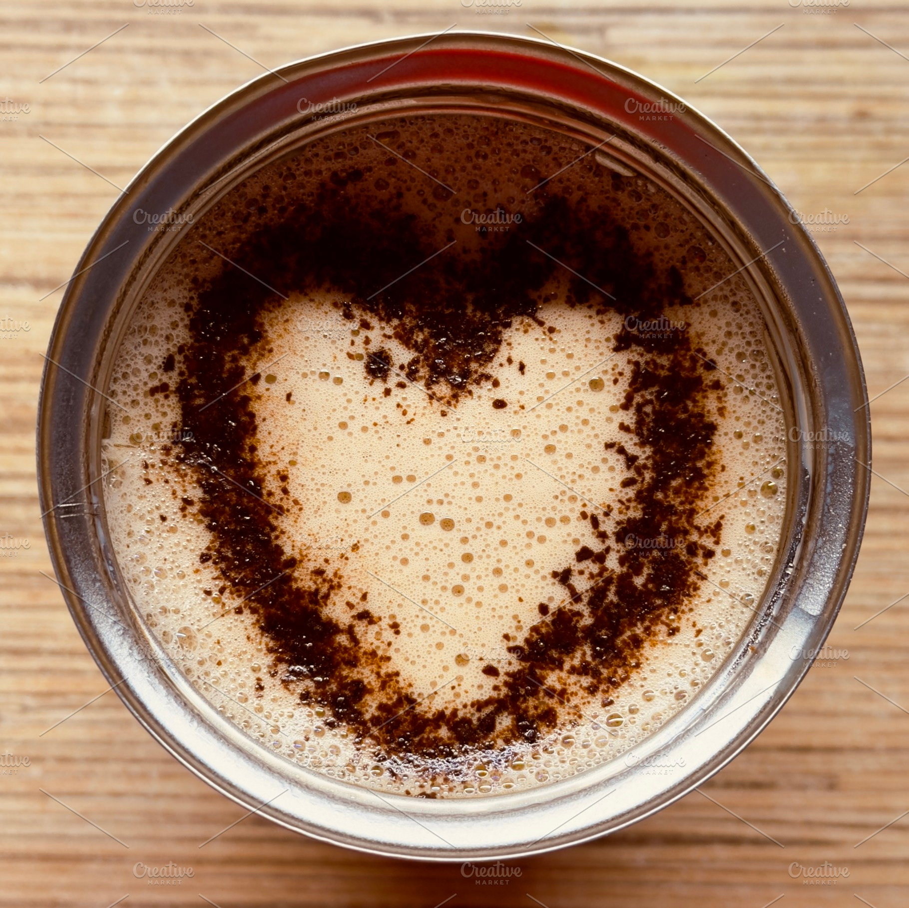A close-up view of a cup of coffee with a heart-shaped pattern formed by coffee, an Industrial Photo by Textures & Backgrounds