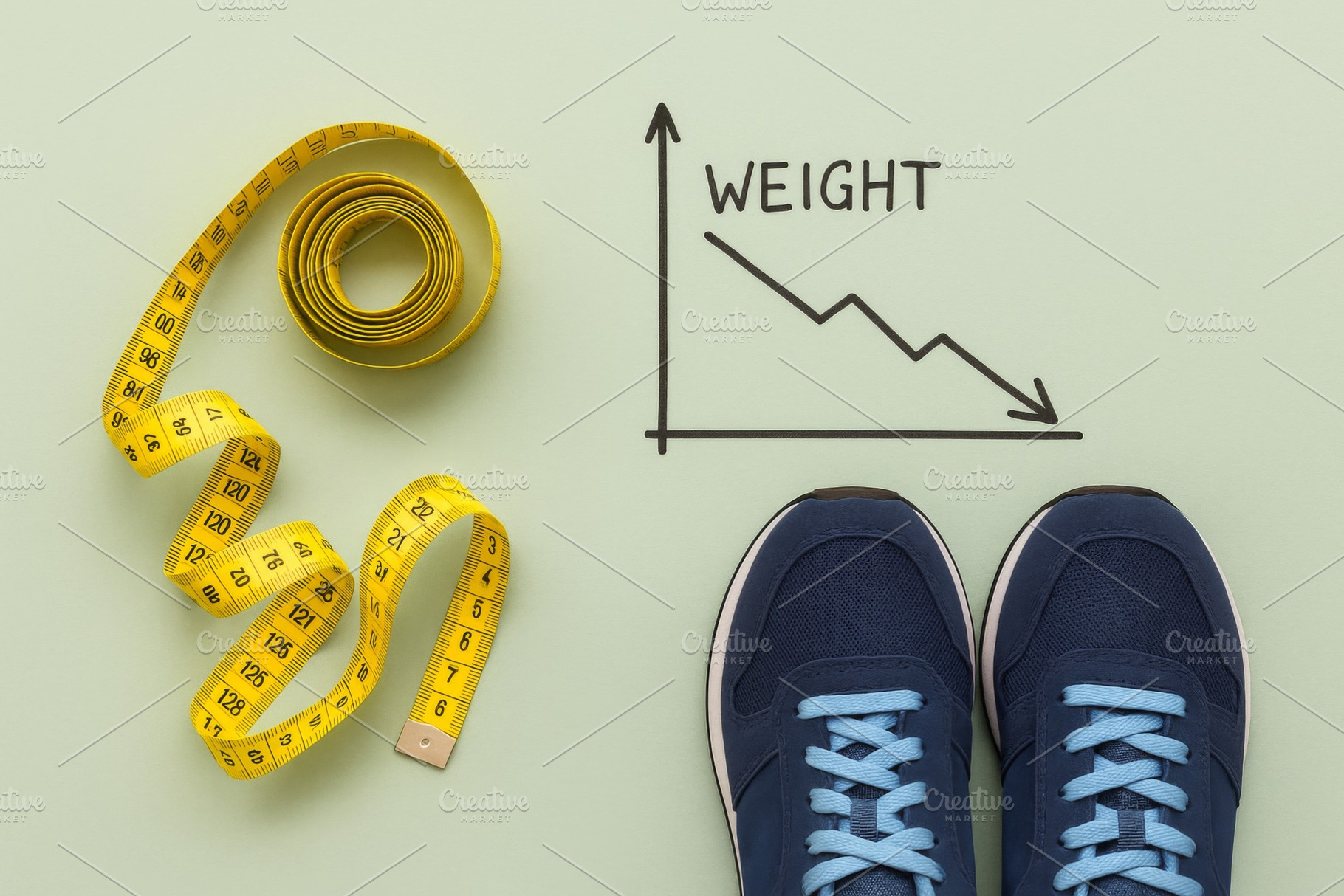 Weight loss concept with graph, tape, a Photo by Dvoevnore photos