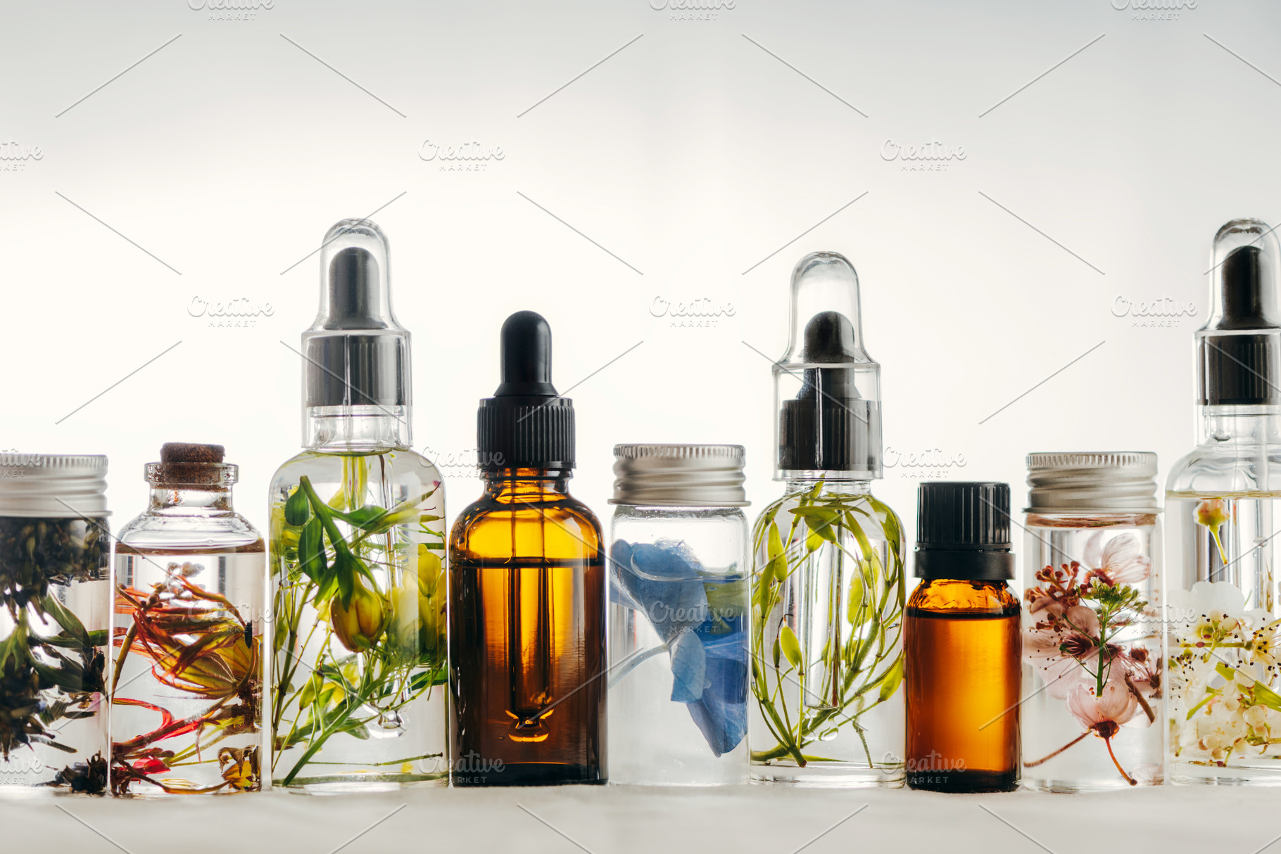 Transparent bottles of essential oil containing essential, oil, and oils, a Beauty & Fashion Photo by SZ IMAGE
