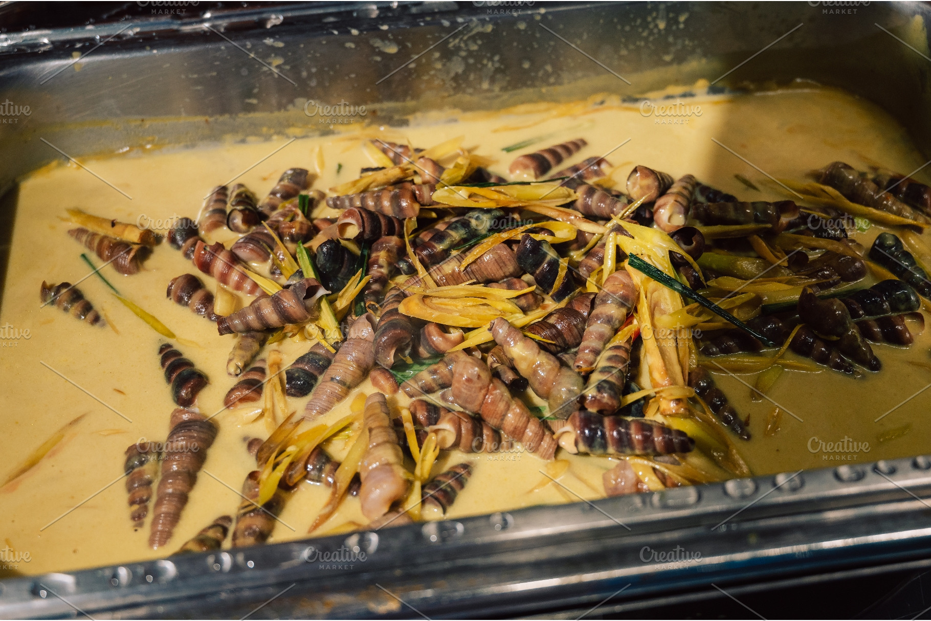 Cooked sea snails in yellow coconut, a Food & Drink Photo by Jan Jack Russo Media