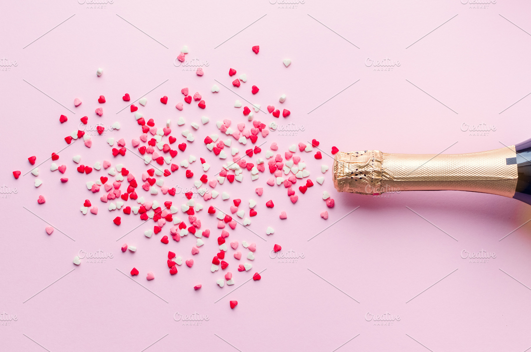 Champagne bottle on pink background containing champagne, hearts, and flat lay, a Food & Drink Photo by NelliKovalchuk