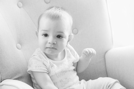 Portrait of a nine month old baby sitting in a rocking chair, a Person Photo by rubenchase
