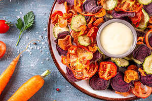 Healthy air fried vegetables chips with white sauce dip, a Food & Drink Photo by Rimma