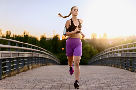 Woman running on a bridge at sunrise, a Sports & Recreation Photo by Perpis