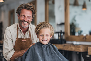 Happy boy getting haircut smiling ba, a Photo by Pixeness Studio