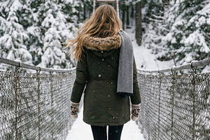 Woman Walking Snow-Covered Bridge, a Person Photo by Virgo Studio