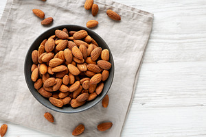 Roasted Almonds in a Bowl, top view. Copy space., a Food & Drink Photo by LiudmylaChuhunova