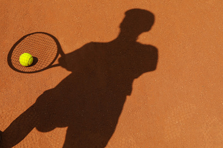Shadow of female tennis player on clay court with ball, a Sports & Recreation Photo by AtlasStudio PRO
