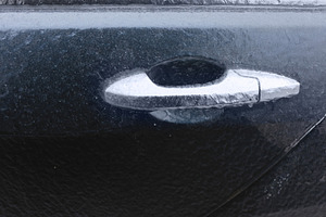 Close-up of an icy car door handle covered in frost, showcasing, a Transportation Photo by Ales Munt