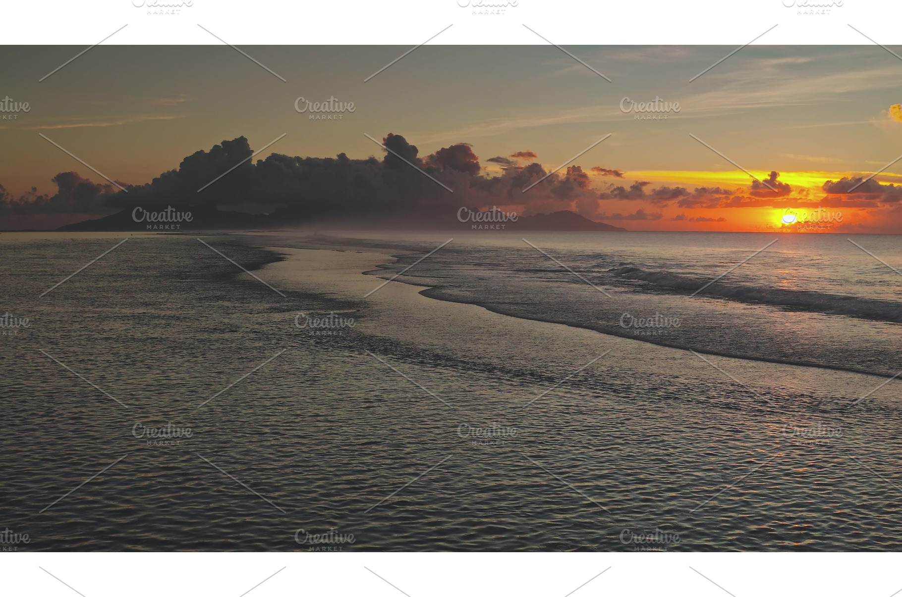 Sunset illuminating calm ocean waves, a Nature Photo by Goinyk