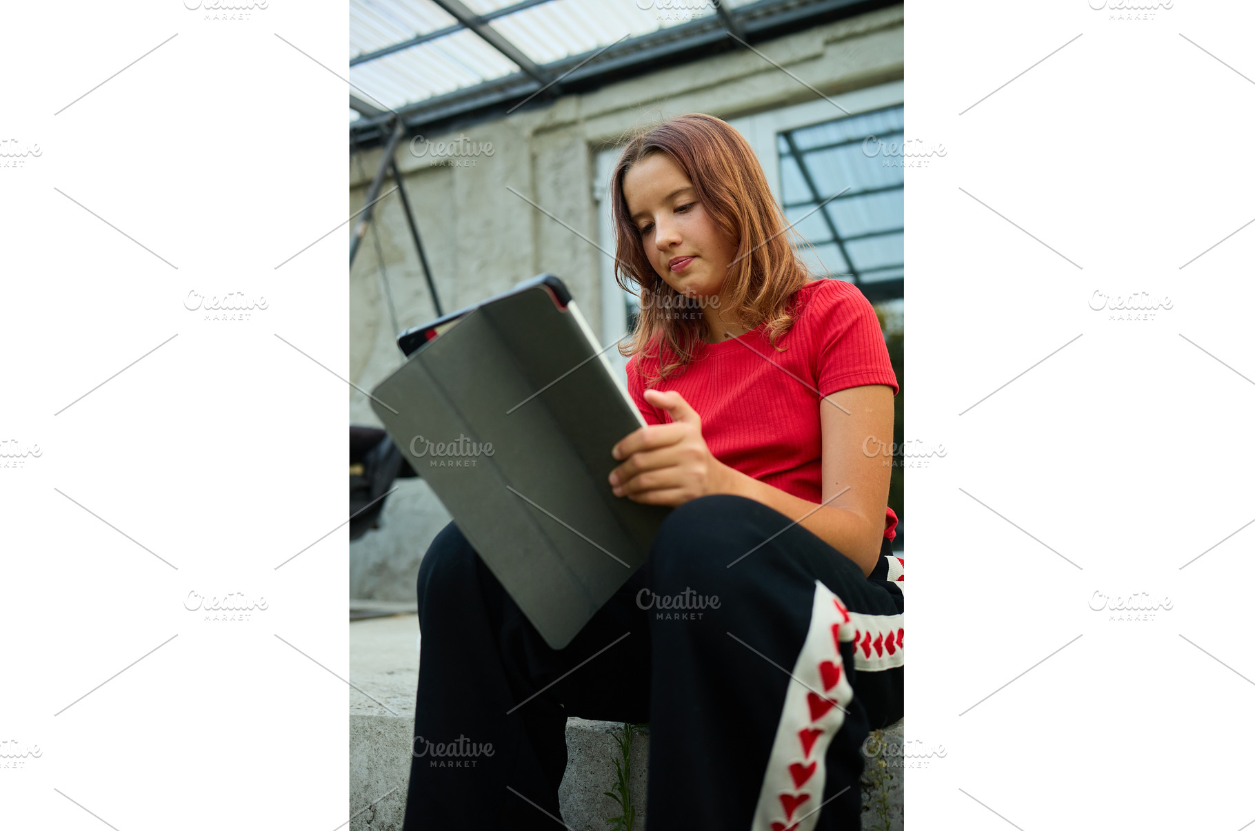School girl uses tablet while, a School & Education Photo by IlliaBondarPhotography