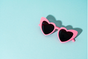 Heart-shaped glasses on a colored, an Arts & Entertainment Photo by Nadia-nb