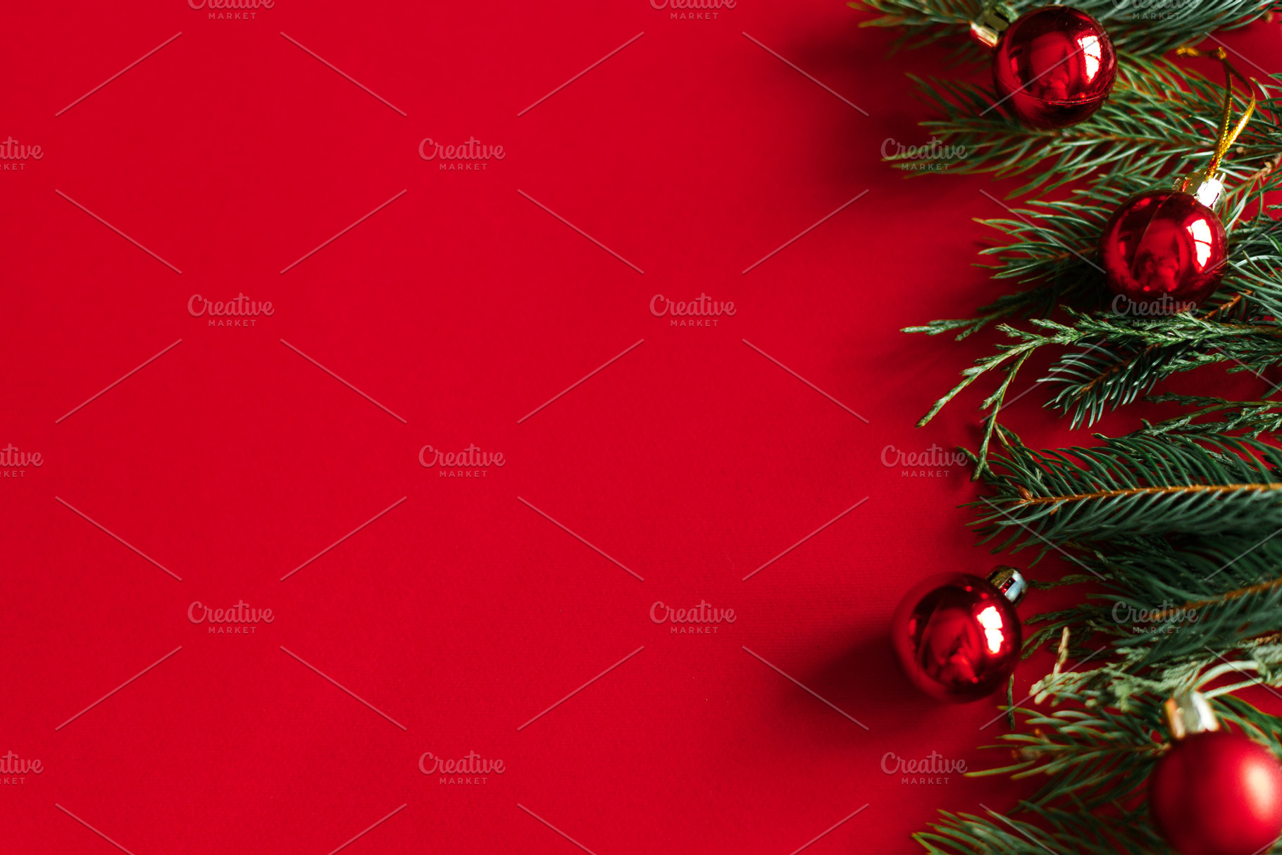 Christmas flat lay. Evergreen fir branches and shiny red baubles, a Photo by Sonjachni