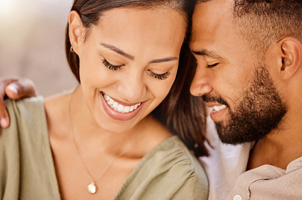 Face, love and couple with a man and woman bonding during an intimate moment together in their home. Smile, romance and happy with a young male and female spending time together in their house, a Photo by Peopleimages.com