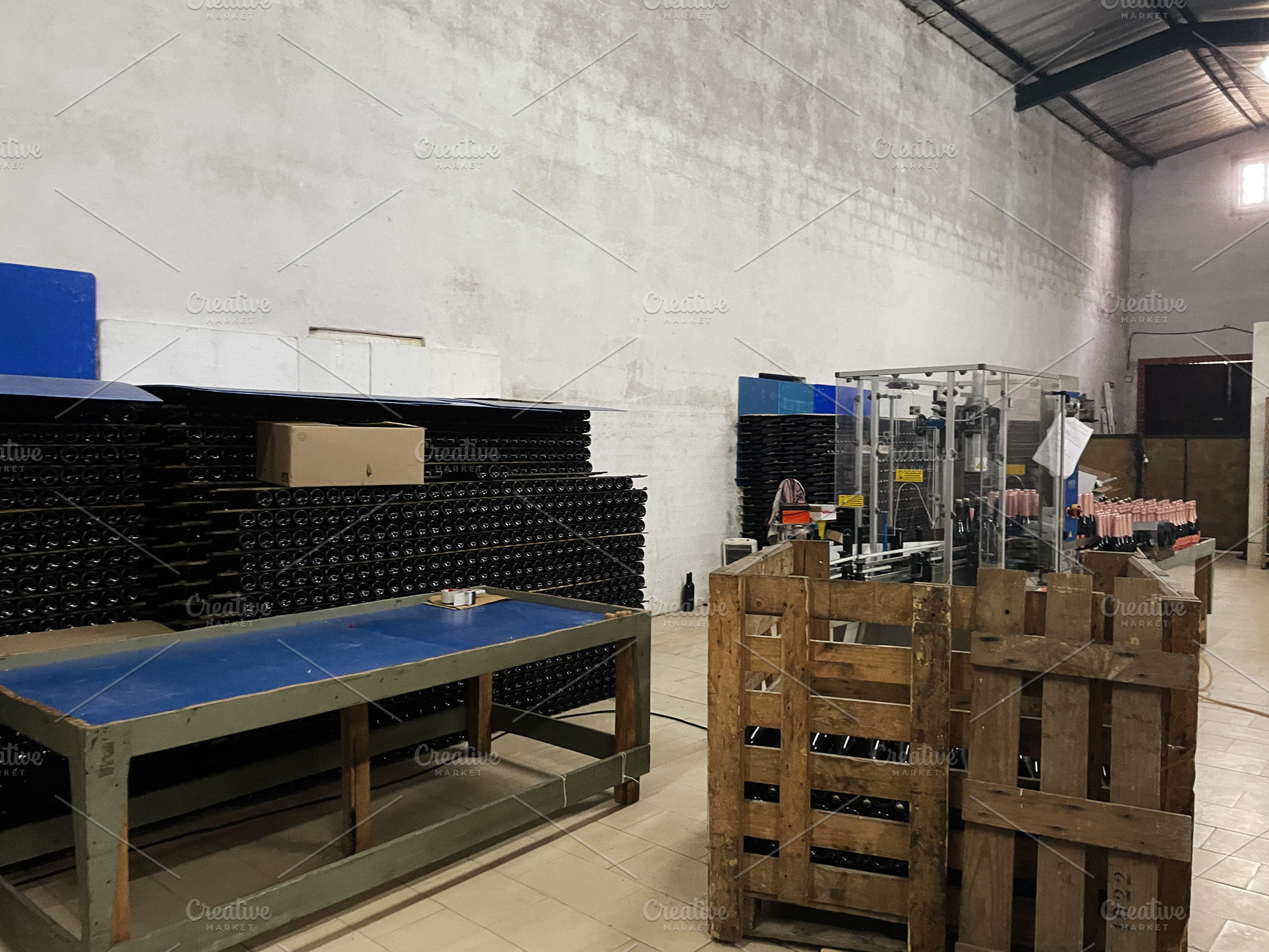 Industrial bottling workshop with machinery and storage racks, a Photo by AS photostudio