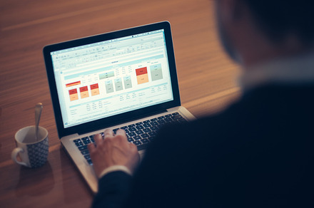 Man working at computer containing computer, laptop, and man
