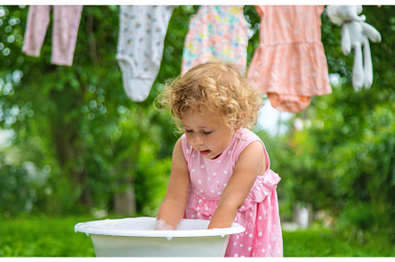 The child washes clothes and toys, a Person Photo by yanadjana