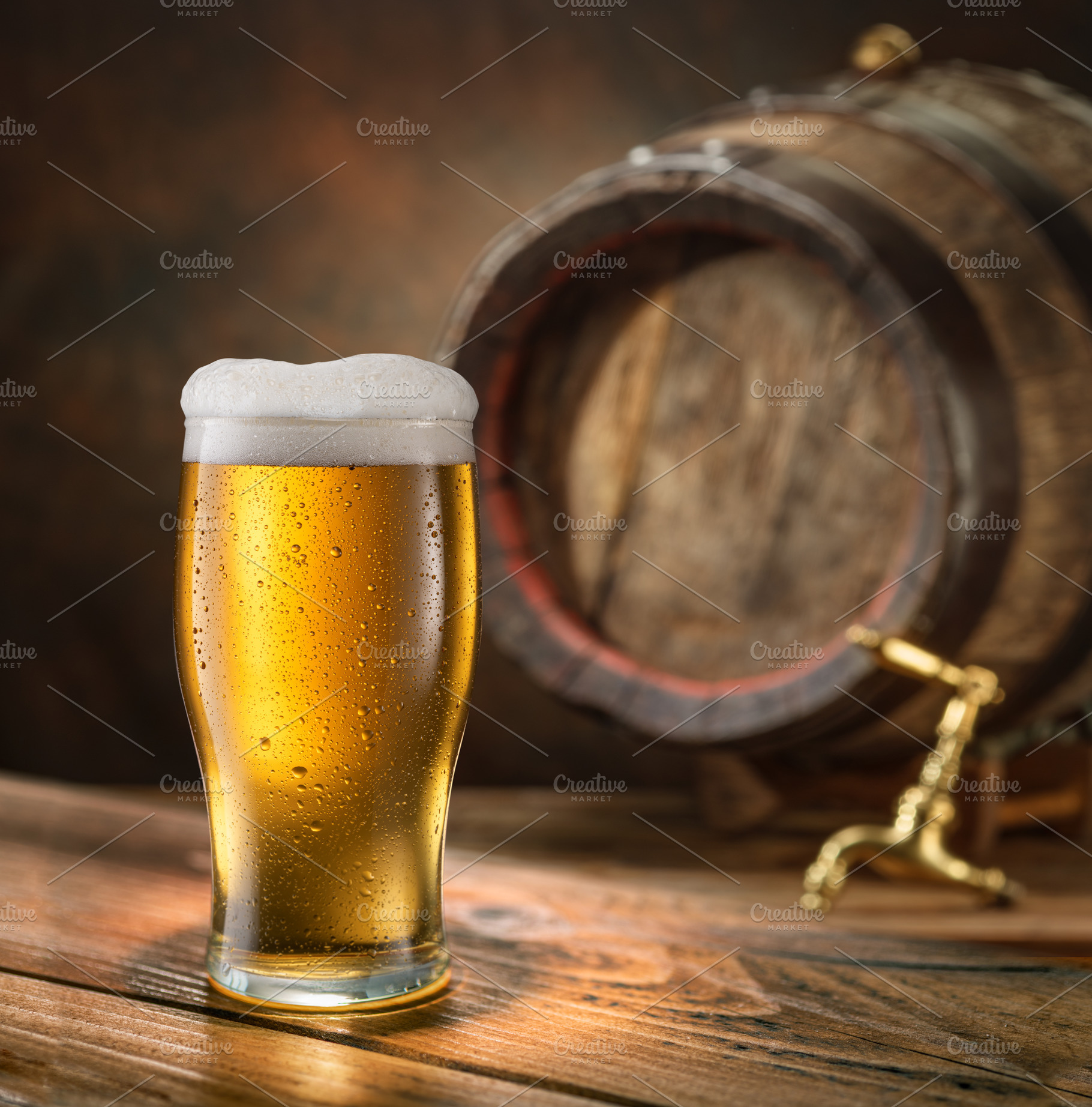 Glass of beer and wooden beer cask, a Food & Drink Photo by Volff