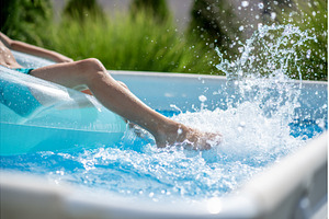 Legs of boy swimming pool sitting on, a Nature Photo by HalfPoint