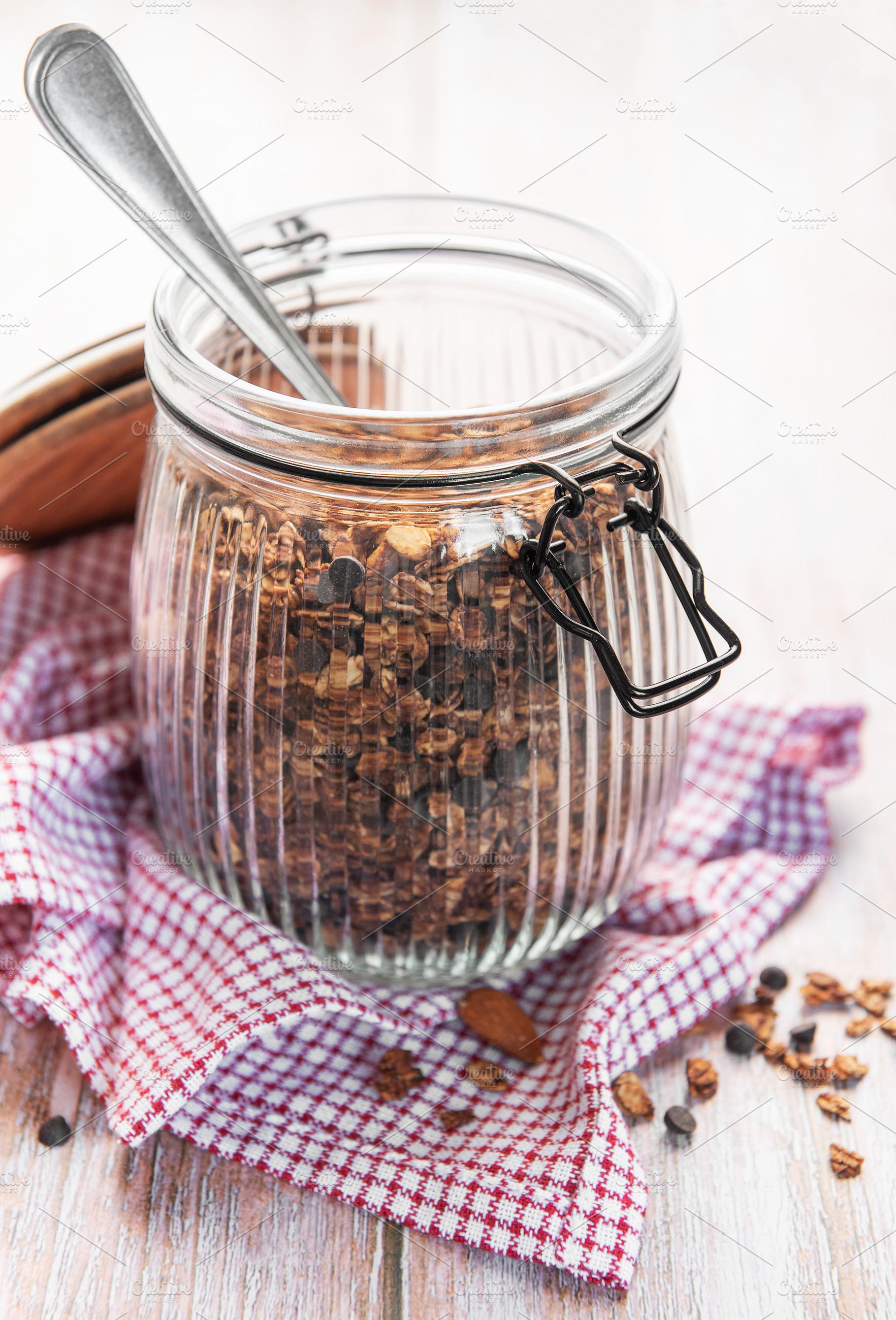 Homemade granola cereal with chocolate chips in jar, a Food & Drink Photo by Olena Rudo