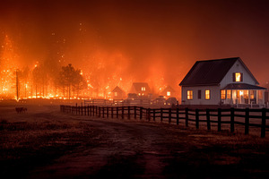 Wildfire approaching farmhouse at night with blazing forest, glowing embers, sm, a Photo by AS photostudio