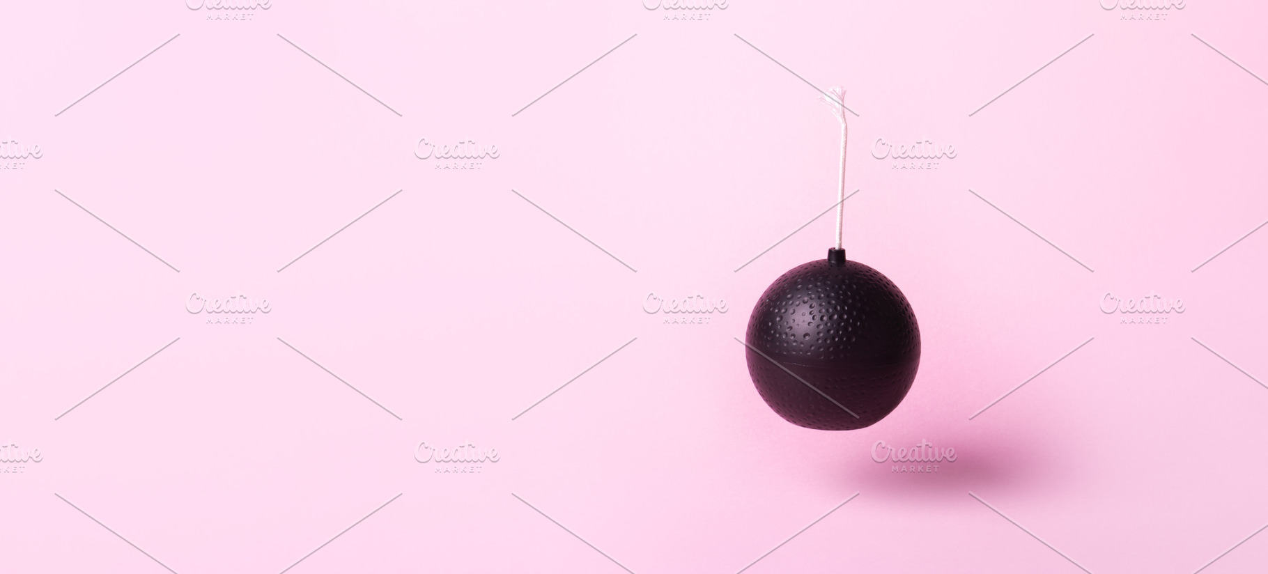 Minimalist black cartoon bomb with fuse suspended against pastel, a Technology Photo by Ales Munt